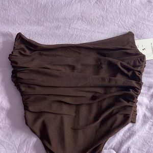 Selling a brown corset top, in the lower part of the corset it does a V form